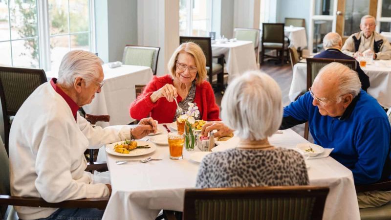 Group of seniors seated at dining table